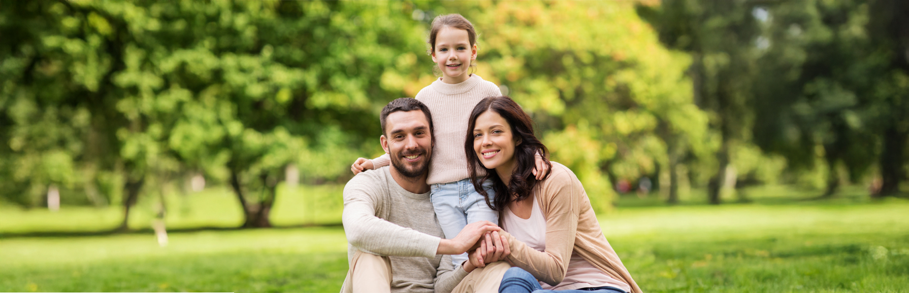 A portrait of a husband and wife with their daughter