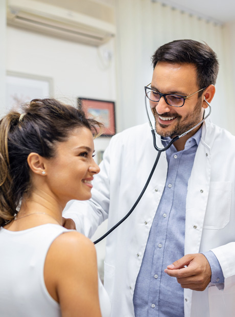 Healthcare professional using stethoscope during exam